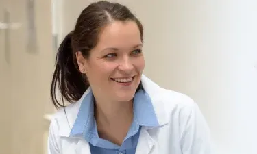 Nurse Practitioner Who Went From RN to MSN Online Smiling with Patient