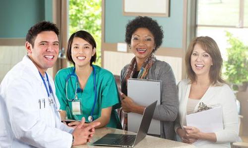 Public Health Nurse Smiling with Team of Healthcare Professionals